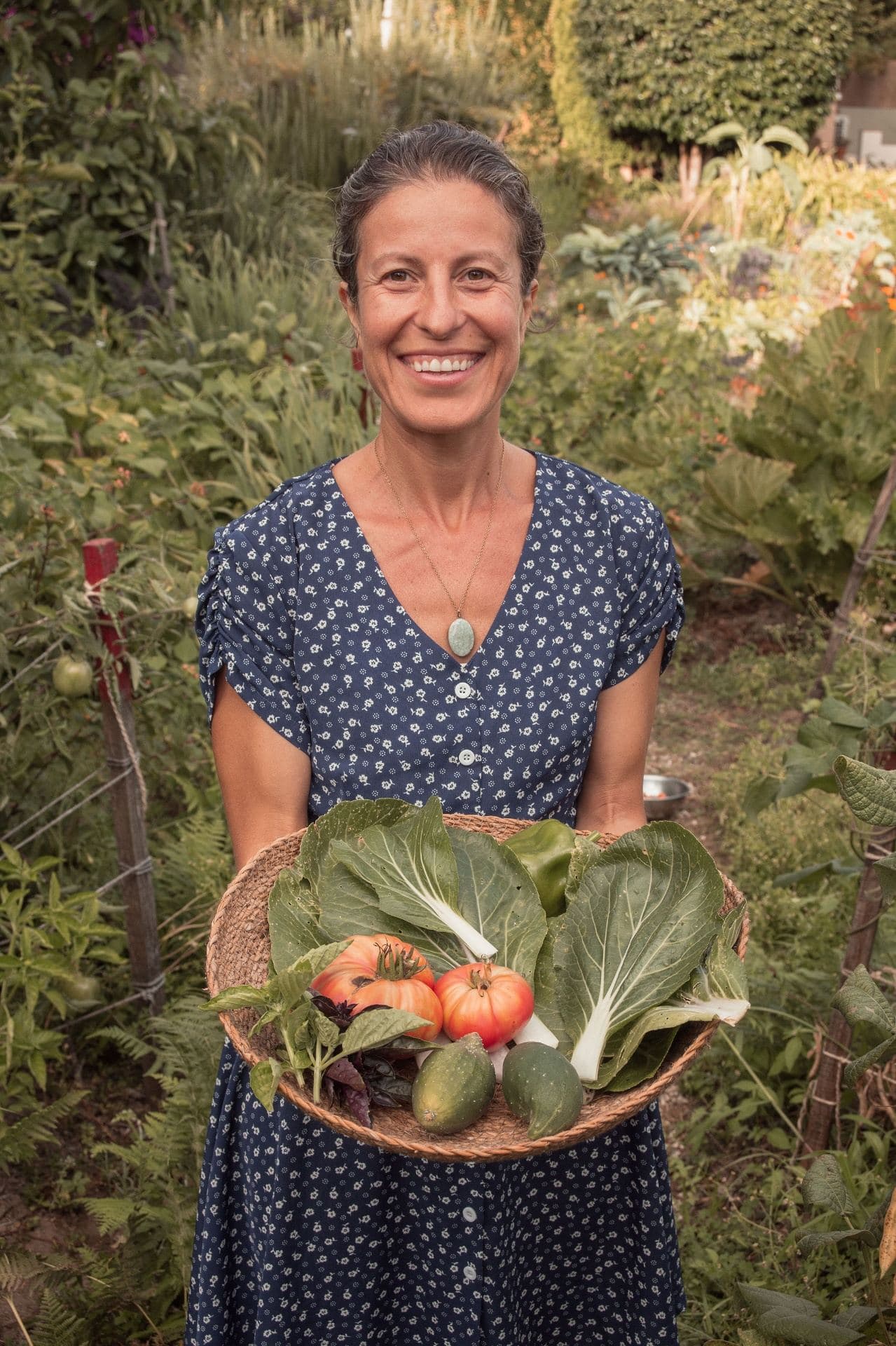 Health coach harvesting fresh beans in the garden